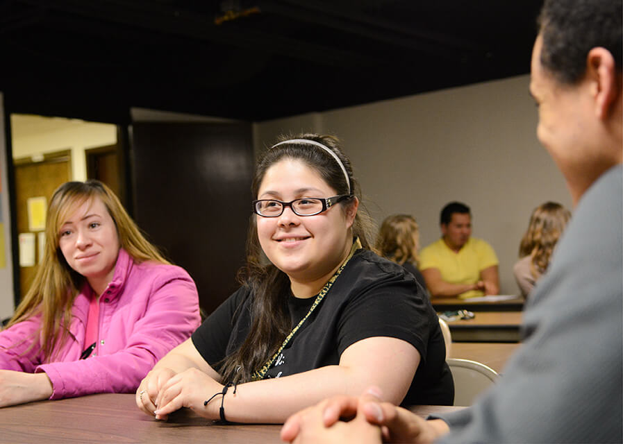 Female students listen to presentation