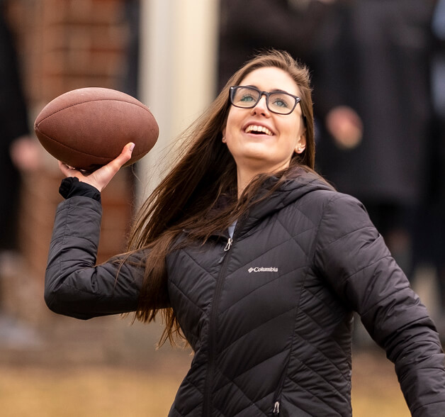 Student player throwing a football